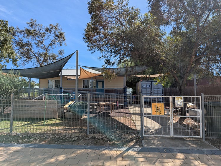Photo shows the outside building of our B4K facility and playground equipment.
